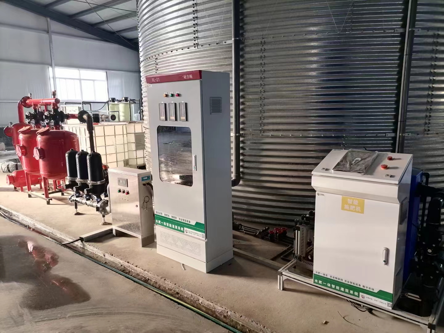 Water storage tank beside irrigation pipework and control cabinets